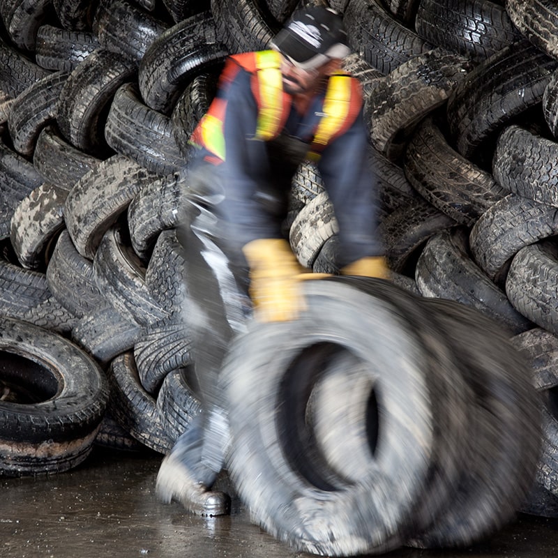 A worker at Emterra Tire Recycling moves a tire through the plant located in Brampton, ON. 