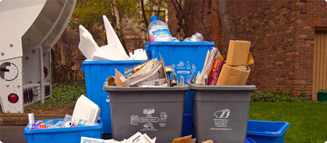Emterra municipal waste management bins with recyclables for curbside collection services in Canada.